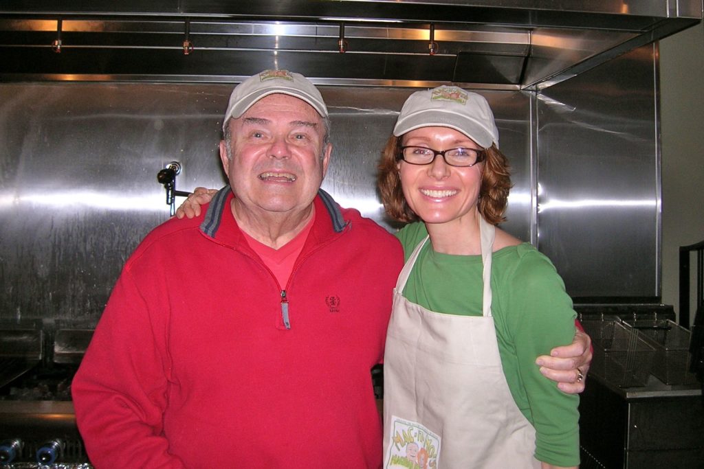 Mo and her dad Mac posing side by side in the kitchen.