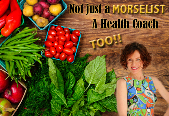 Health coach, Mo The Morselist, stands next to an arrangement of rainbow vegetables.