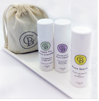 Three Caryl B. Skincare products on a shelf: green tea face cleanser, face cream, face serum.