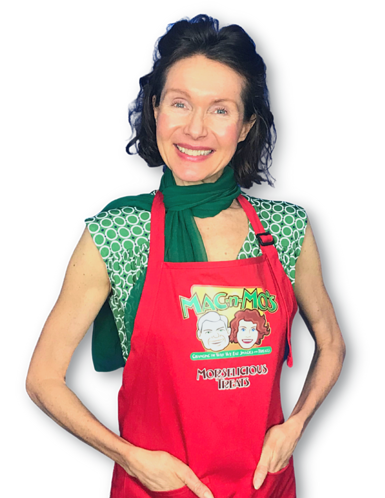 Mo poses with her hands in the pockets of a red apron.